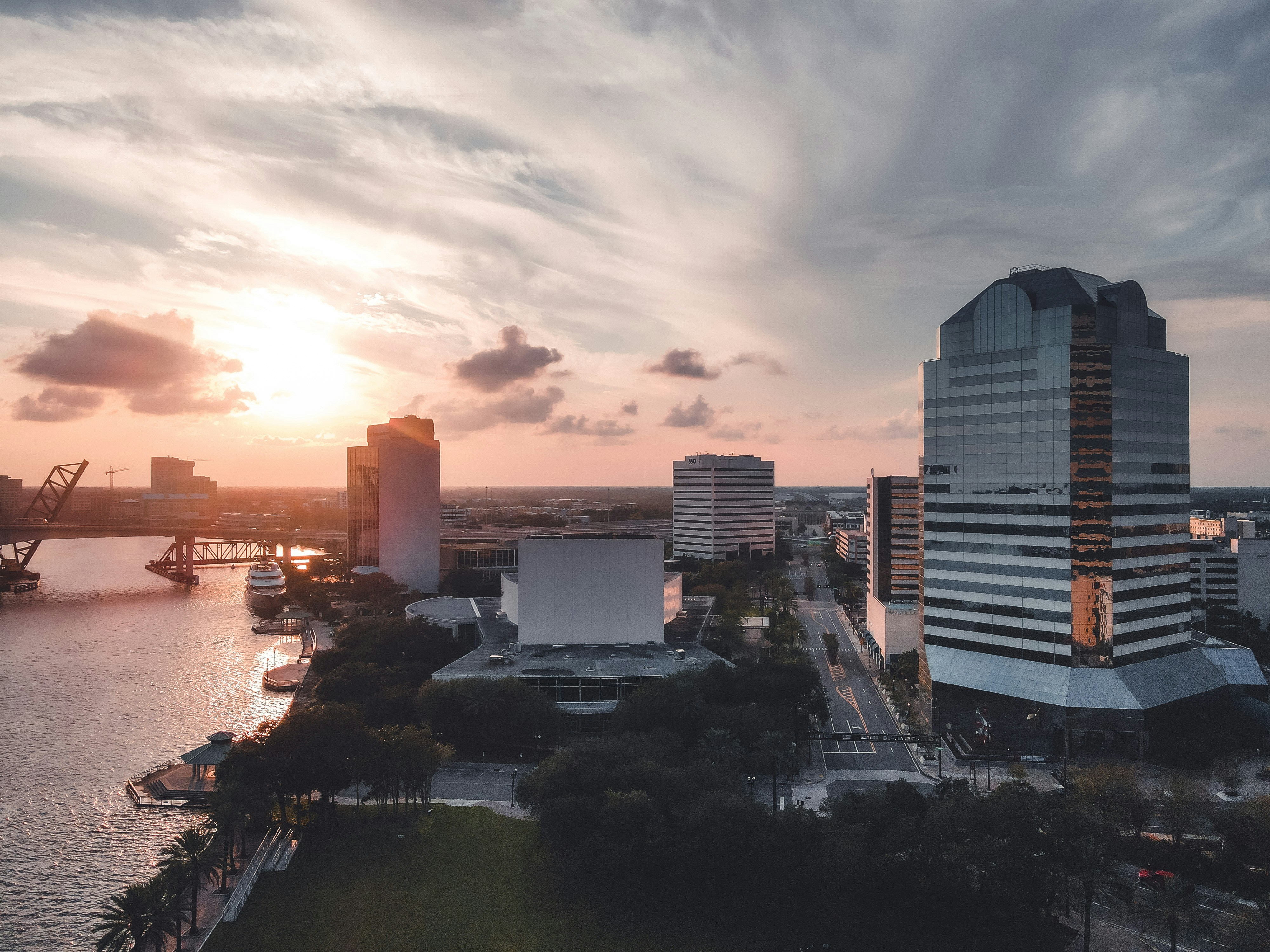city skyline under cloudy sky during sunset