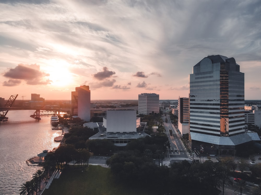 city skyline under cloudy sky during sunset