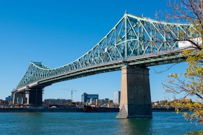 gray bridge over body of water during daytime