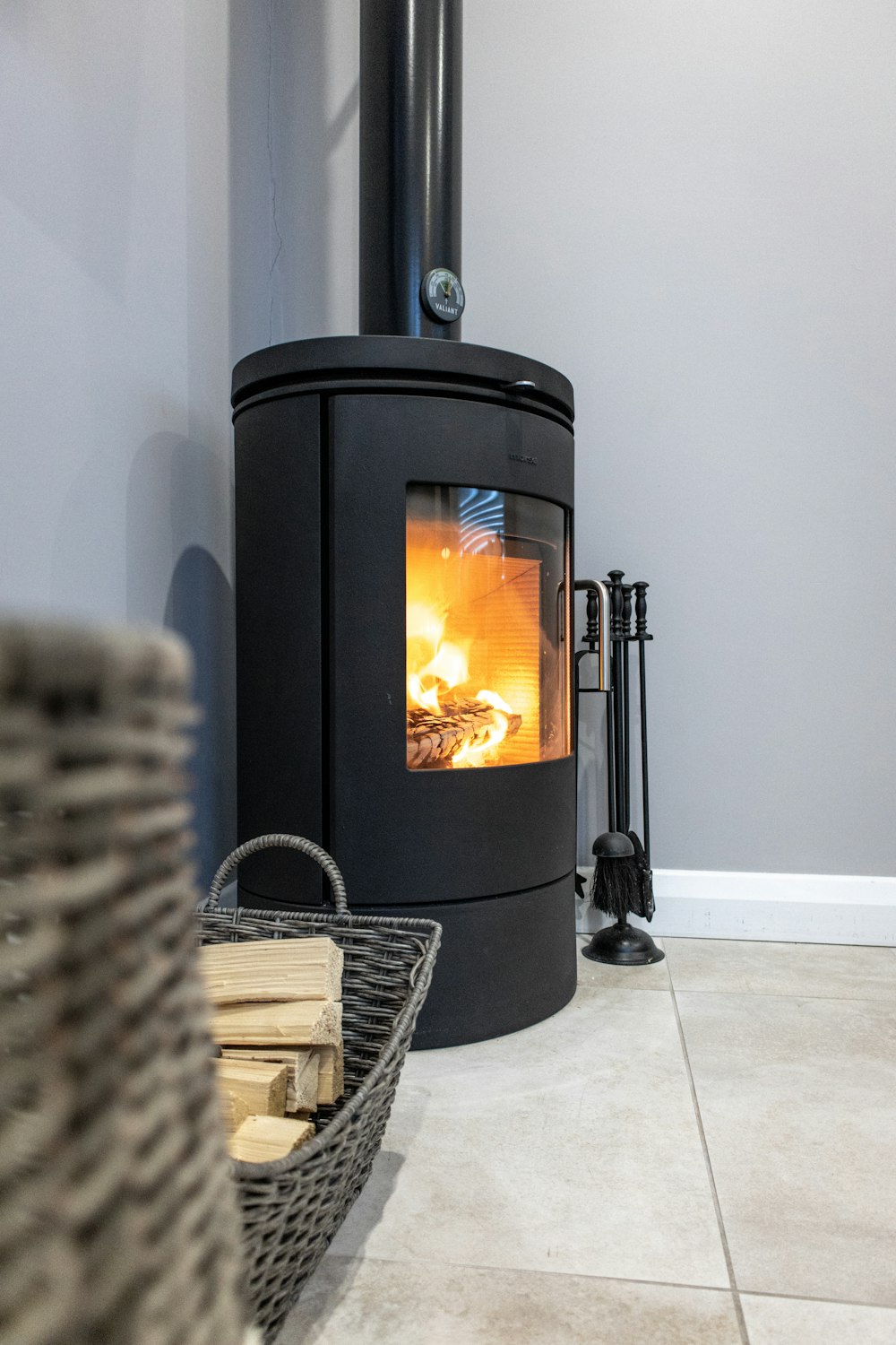 black wood burner near white wall