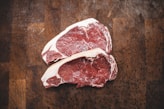 raw meat on brown wooden table