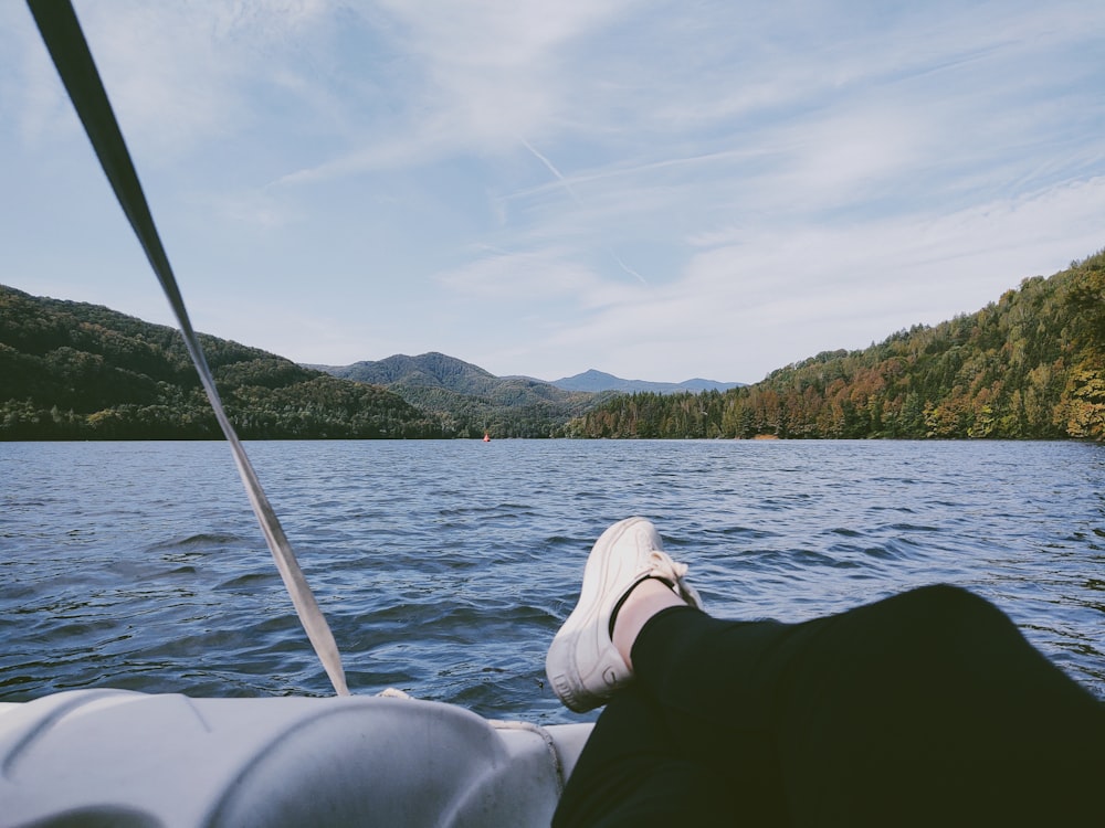 person in black long sleeve shirt sitting on boat during daytime