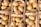 Baskets filled with freshly harvested potatoes arranged neatly. The potatoes have a smooth skin with some dirt specks, indicating they are unwashed. The wooden baskets provide a rustic look to the overall presentation.