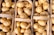 Close-up of golden potatoes in a rustic basket on a wooden table.