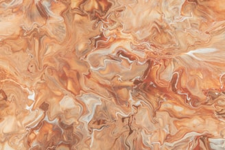 An abstract, fluid art painting featuring swirling patterns and textures. The colors blend seamlessly into each other, creating a marbled effect with various shades.