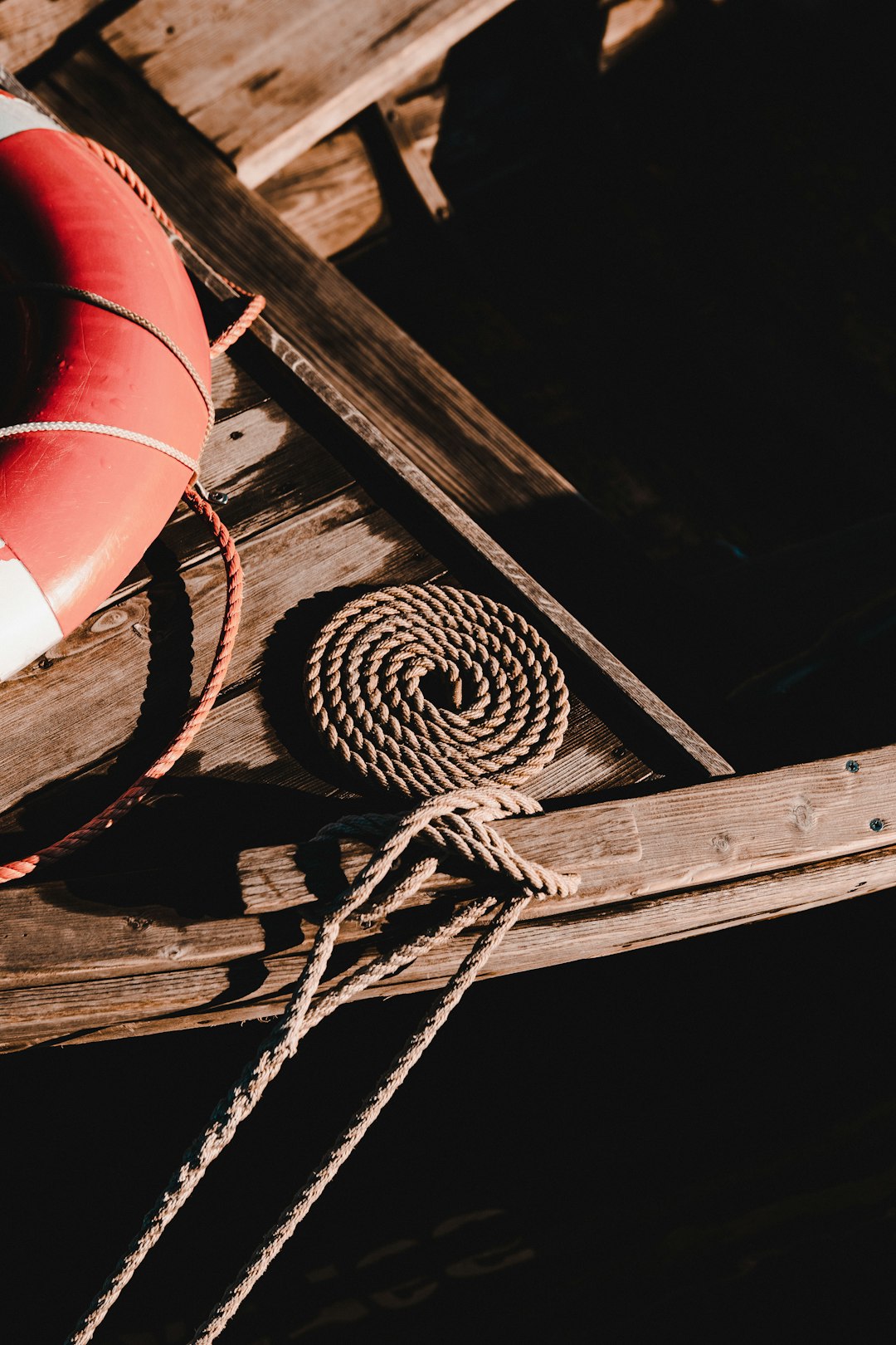 white and black rope on brown wooden plank