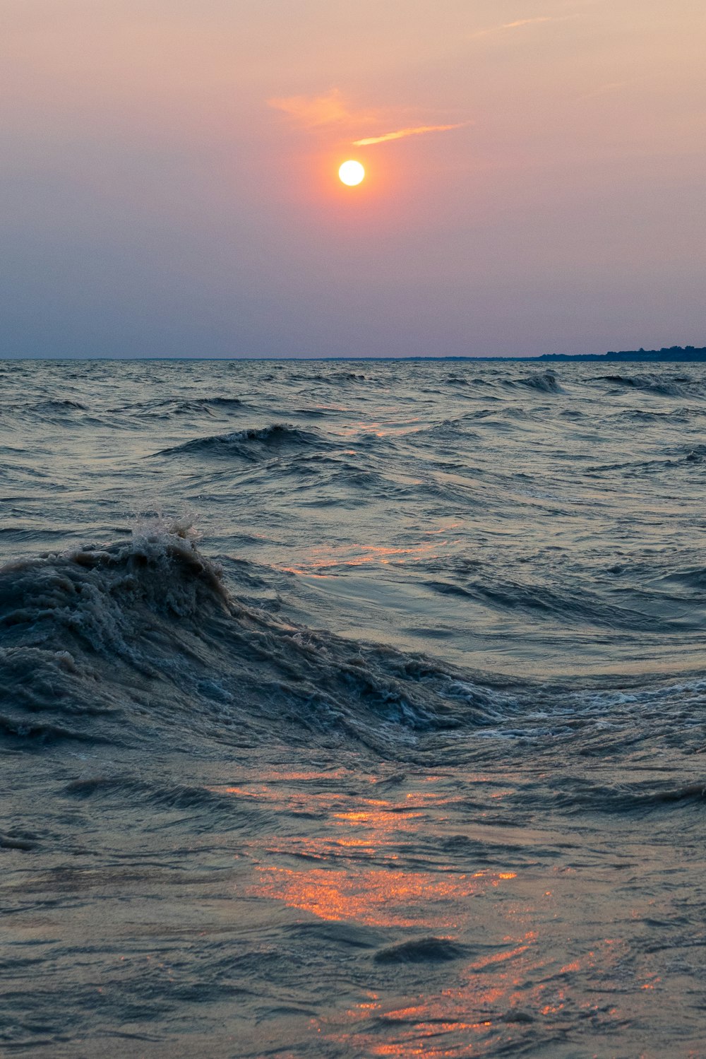 ocean waves under blue sky during sunset