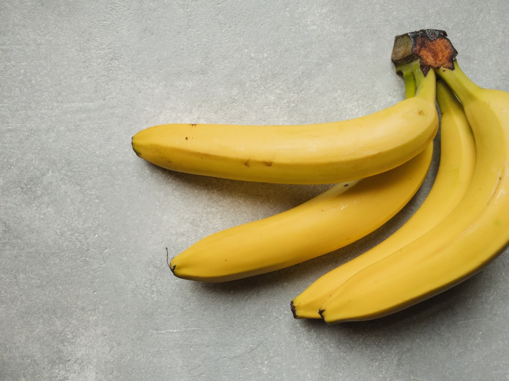 yellow banana fruit on gray table