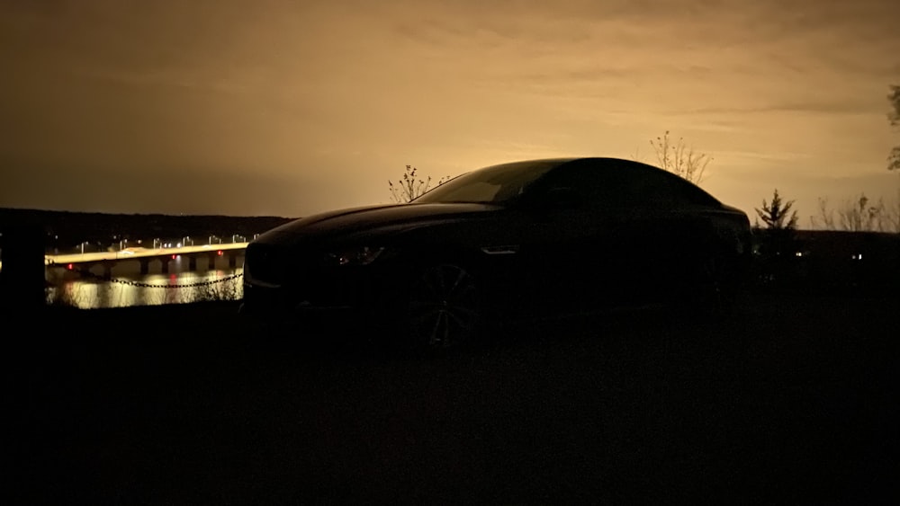 black car on road during sunset