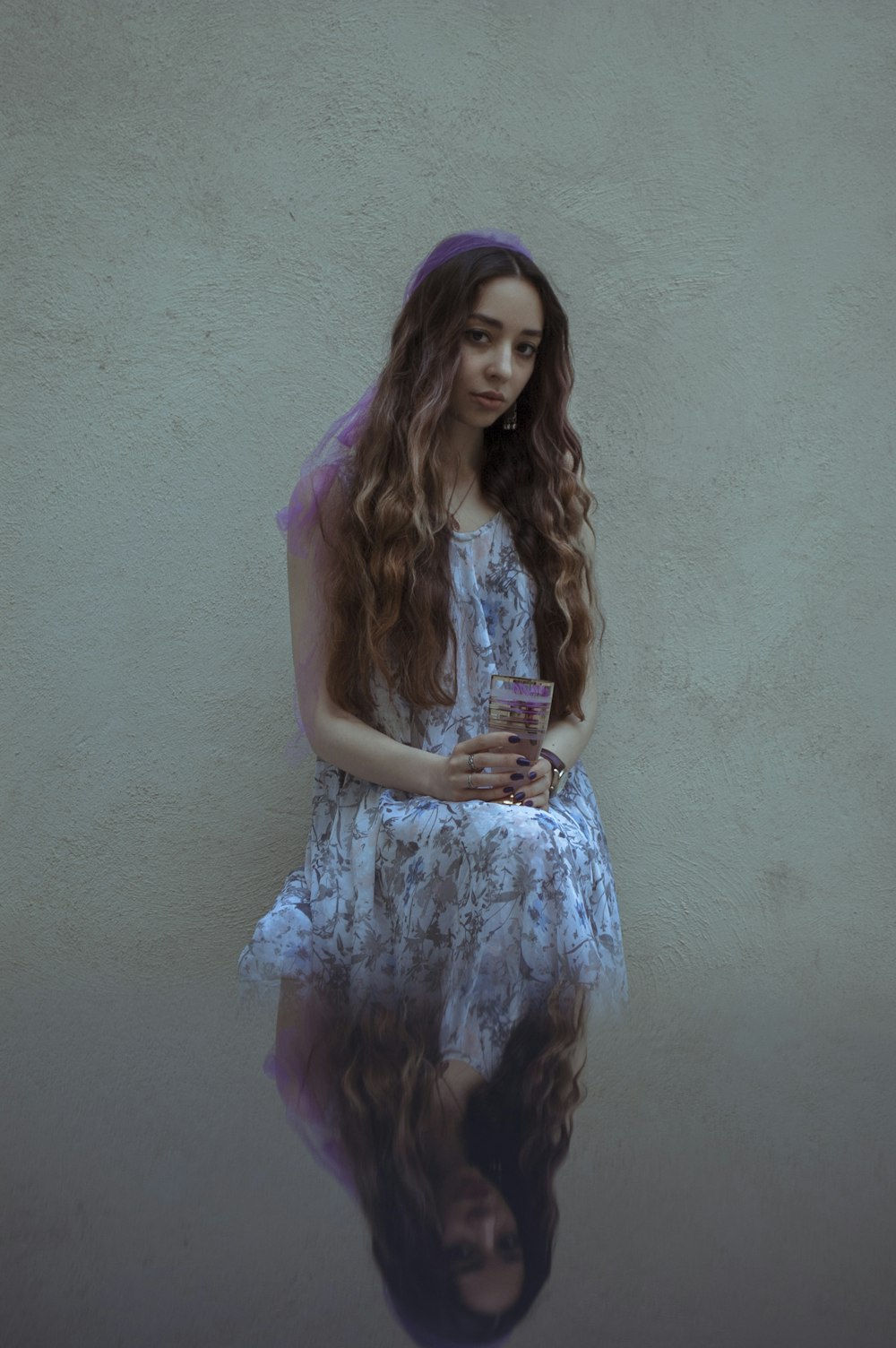 woman in blue and white floral sleeveless dress