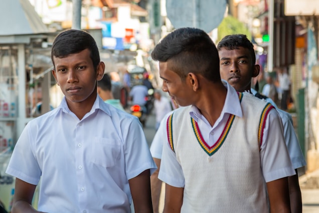 man in white polo shirt standing beside boy in white polo shirt