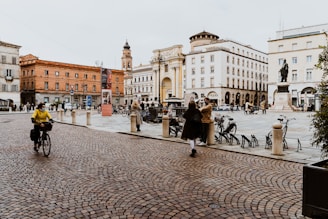 people walking on sidewalk near building during daytime