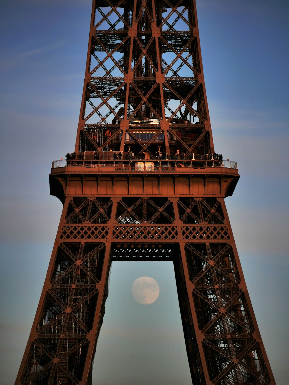 brown tower with moon in the sky