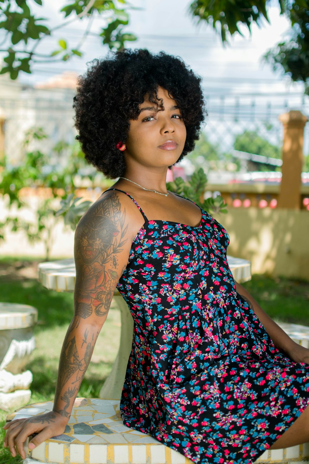 woman in black red and white floral spaghetti strap dress