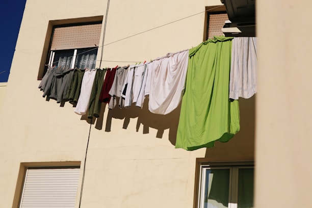 Laundry bags being collected from a residential doorstep on a sunny day.