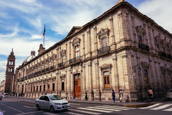 Cars parked in front of brown concrete building during daytime — Morelia, Mexico