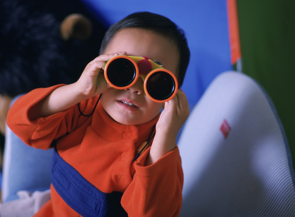 woman in orange shirt wearing brown sunglasses