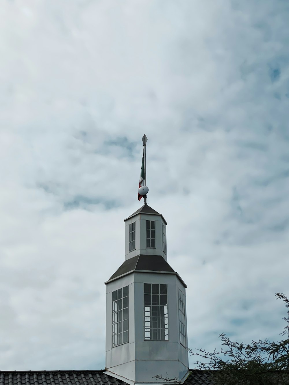 white and black concrete building under white clouds during daytime