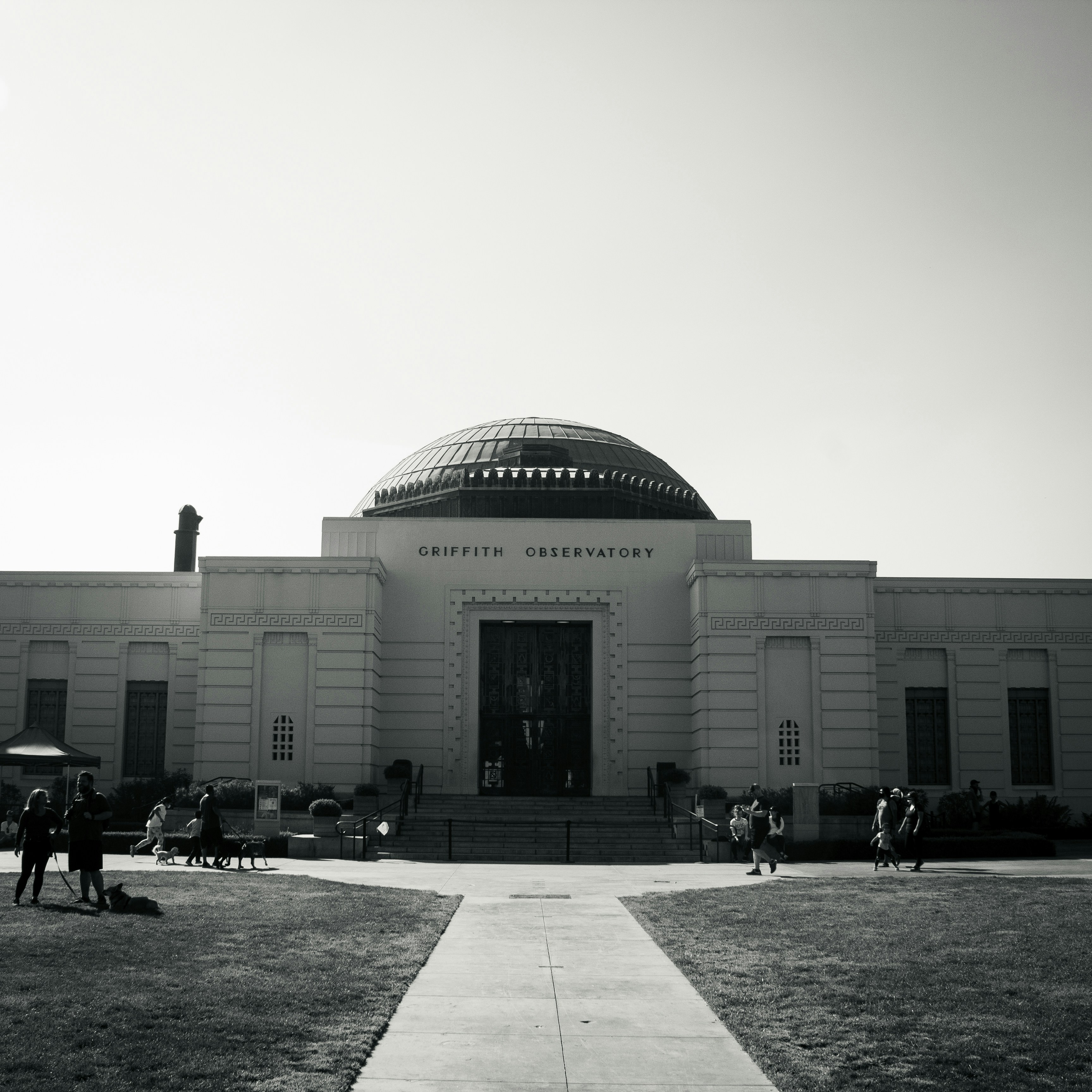 people walking near white concrete building during daytime