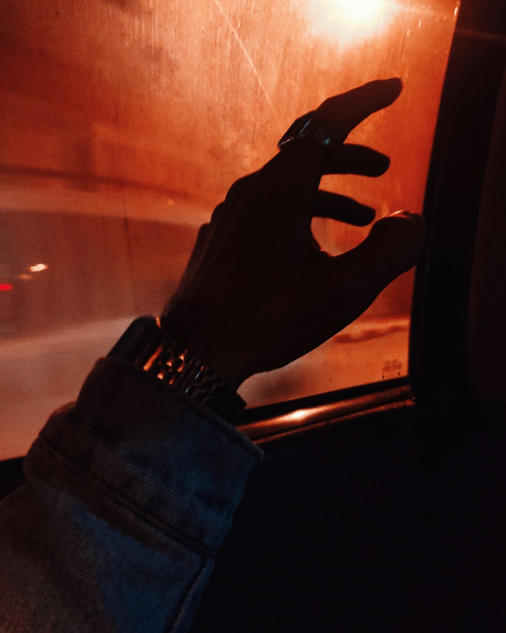 a hand reaching out of a car window