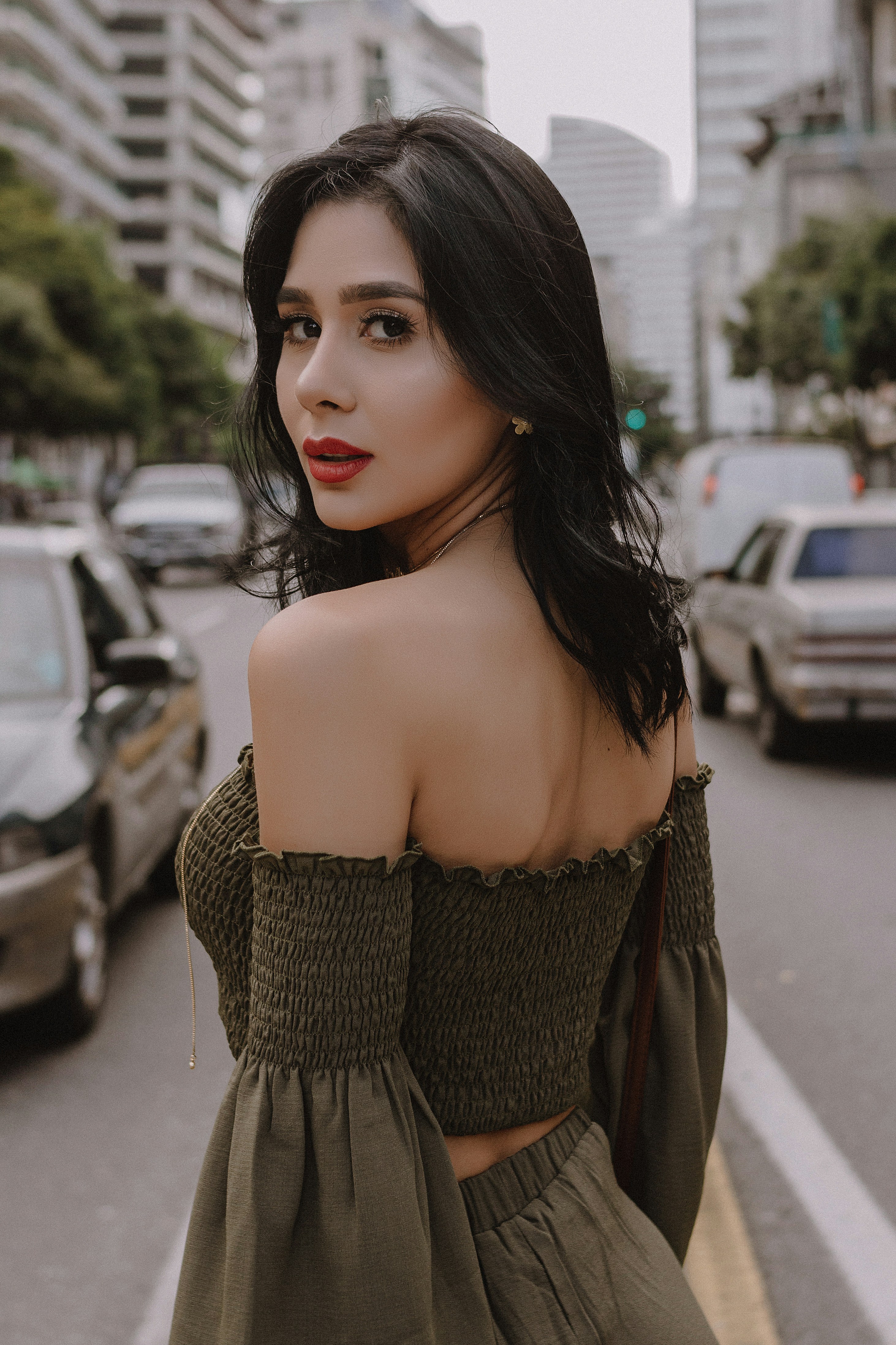 great photo recipe,how to photograph girl on the city; woman in black off shoulder top standing on road during daytime