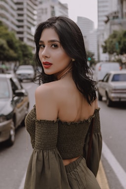 photography poses for women,how to photograph girl on the city; woman in black off shoulder top standing on road during daytime