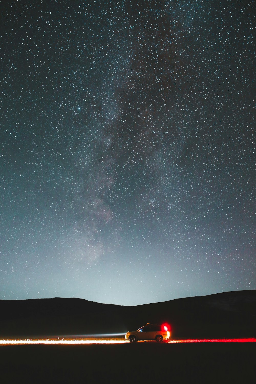 silhouette of mountain under starry night