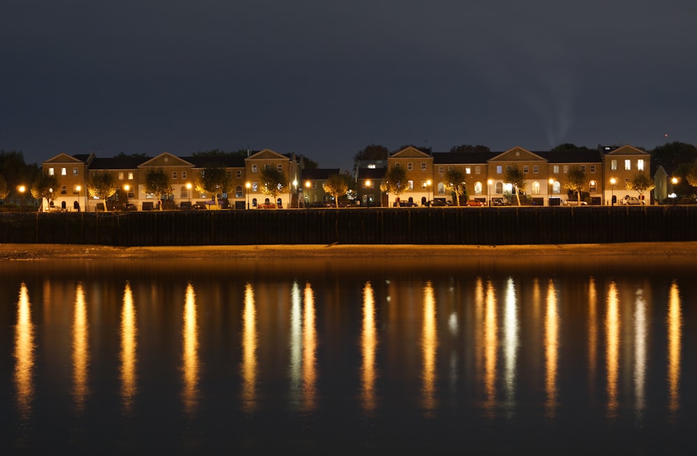 lighted building near body of water during night time