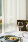 A beautifully set dining table in a hotel restaurant with gourmet dishes.