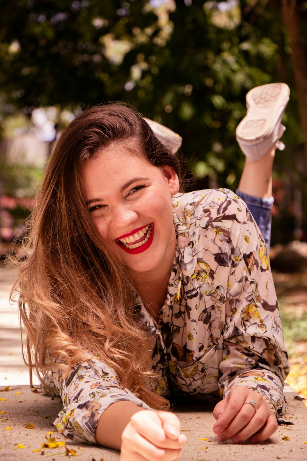 smiling woman in white and black floral shirt