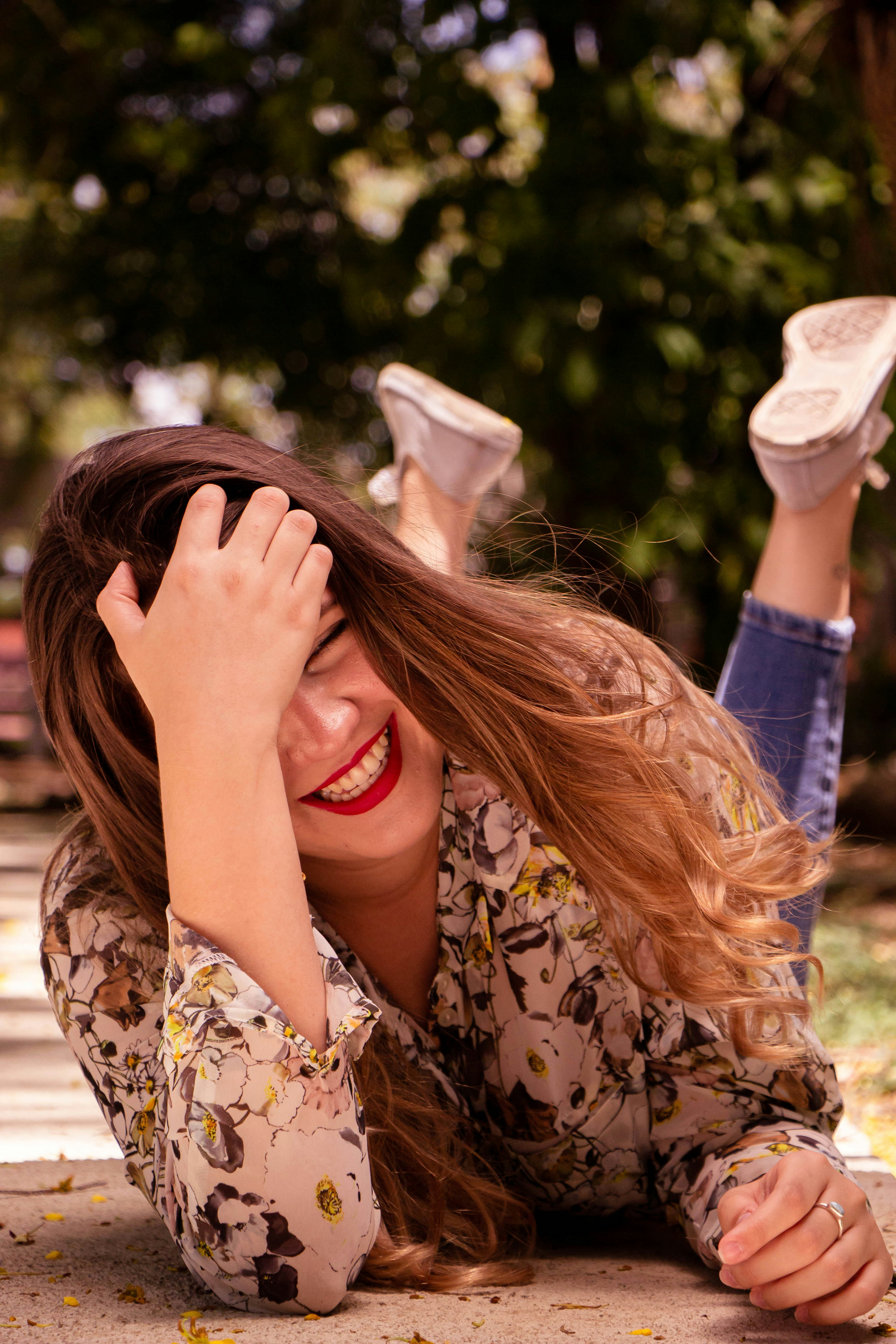 a woman laying on the ground with her hands on her head
