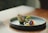 Elegant plating of a classic Ecuadorian dish with a modern minimalist restaurant backdrop.