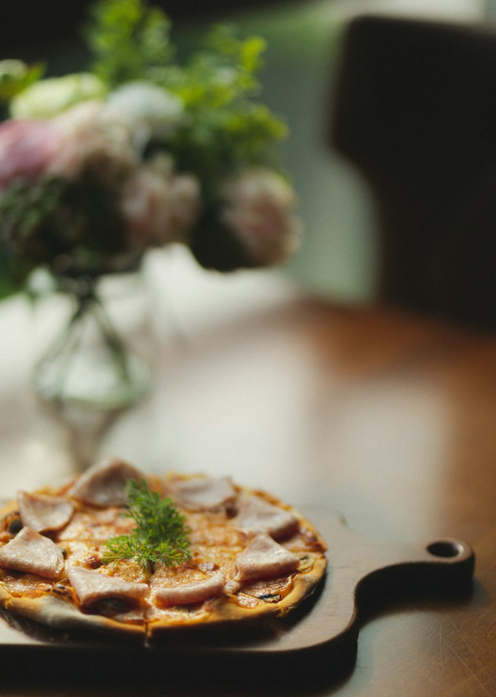 brown pizza on white table