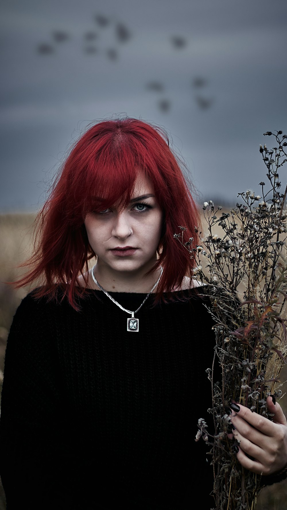 woman in black sweater with red hair