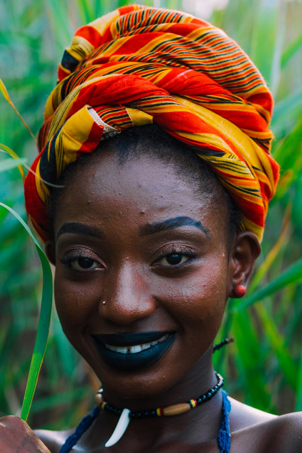 woman in orange and yellow feather headdress