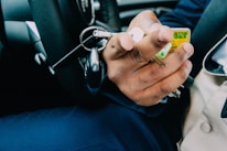 Close-up of hands exchanging car keys in a rental office.