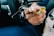 A person handing over car keys during a vehicle ownership transfer process.