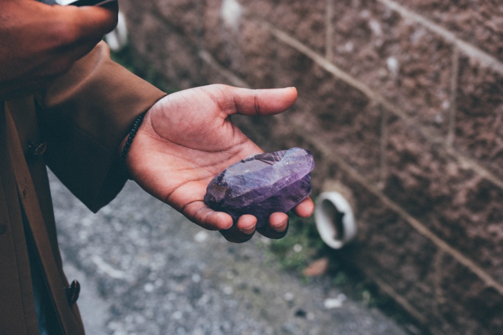 person holding black stone fragment