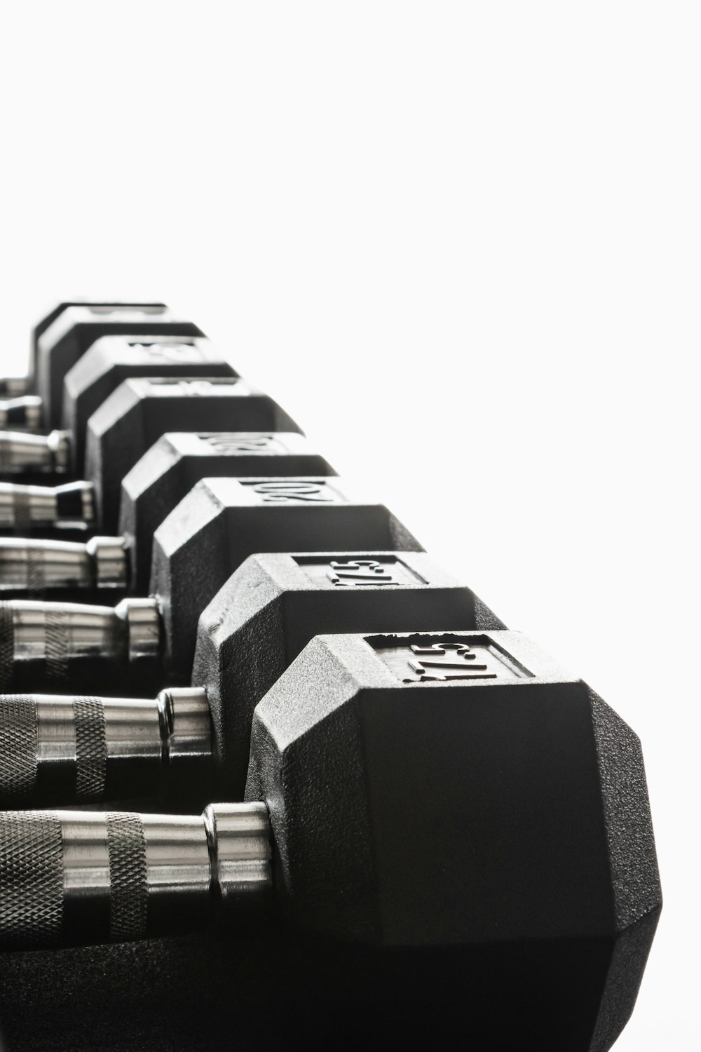 black and silver dumbbells on white background