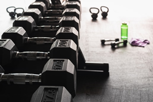 Close-up of vegan creatine gummies arranged on a gym bench with weights in the background