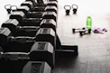 black and gray dumbbells on floor