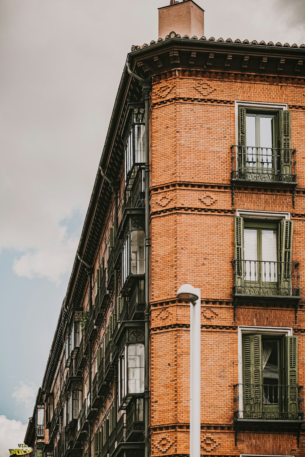 brown brick building under white sky during daytime