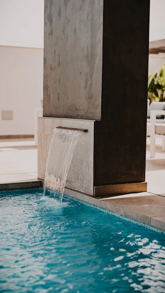 water fountain in the middle of the pool