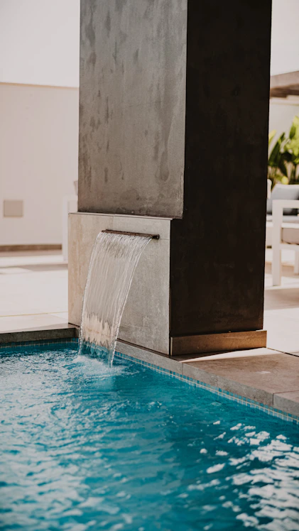 water fountain in the middle of the pool