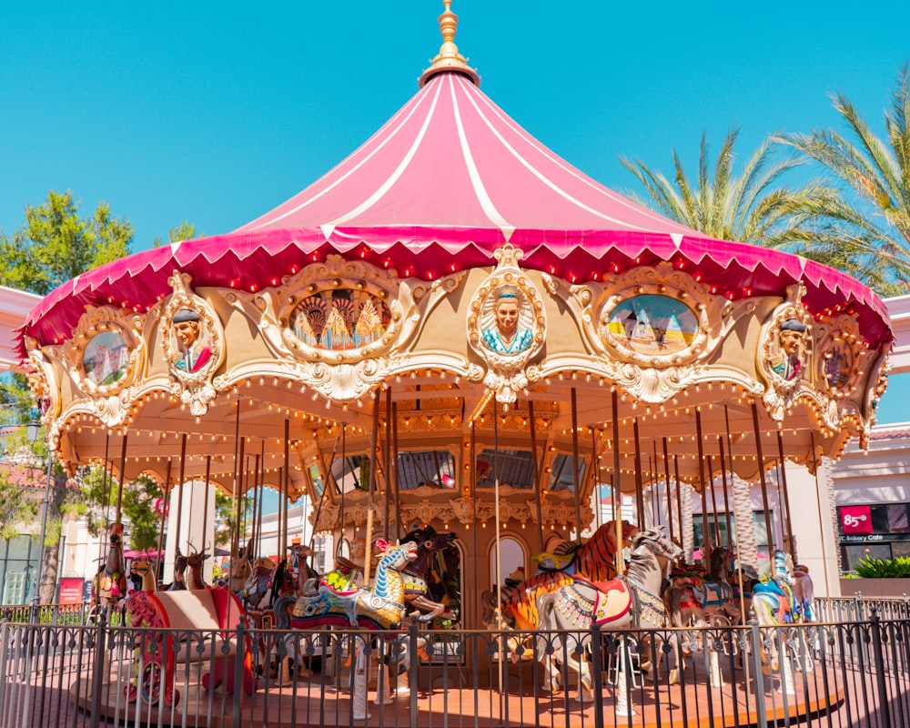 people riding on carousel during daytime