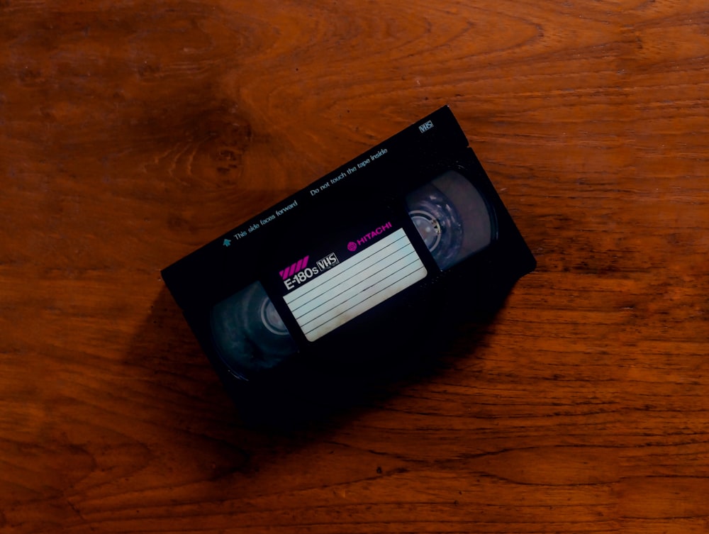 black plastic pack on brown wooden table