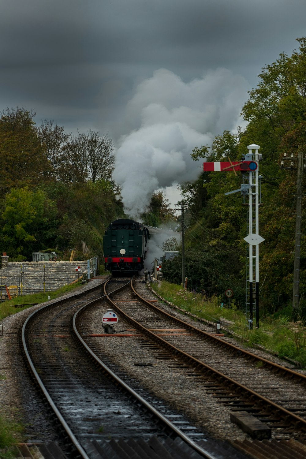 black train on rail tracks during daytime