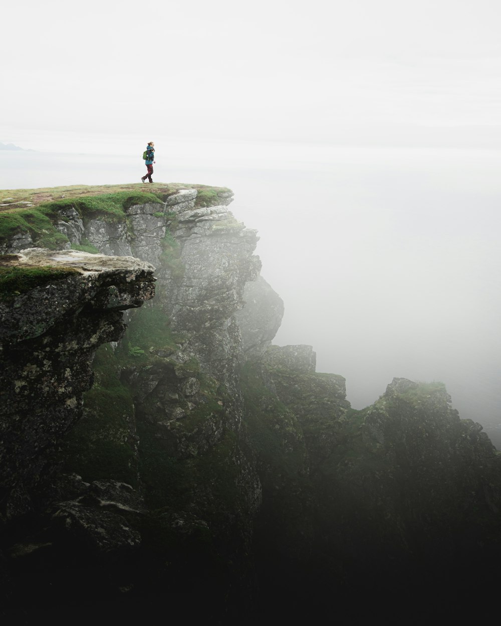 person standing on rock formation during daytime