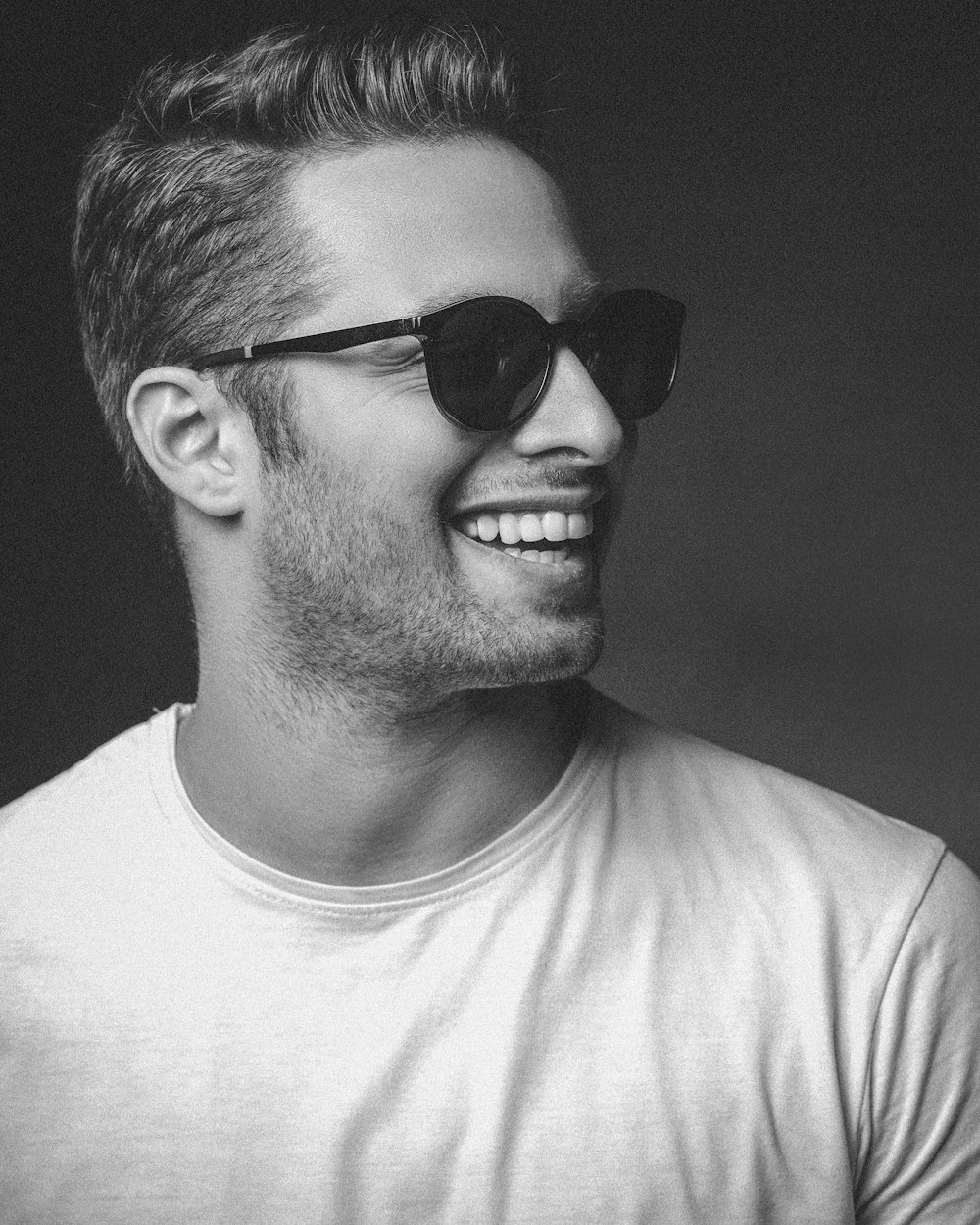 man in white crew neck shirt wearing black sunglasses