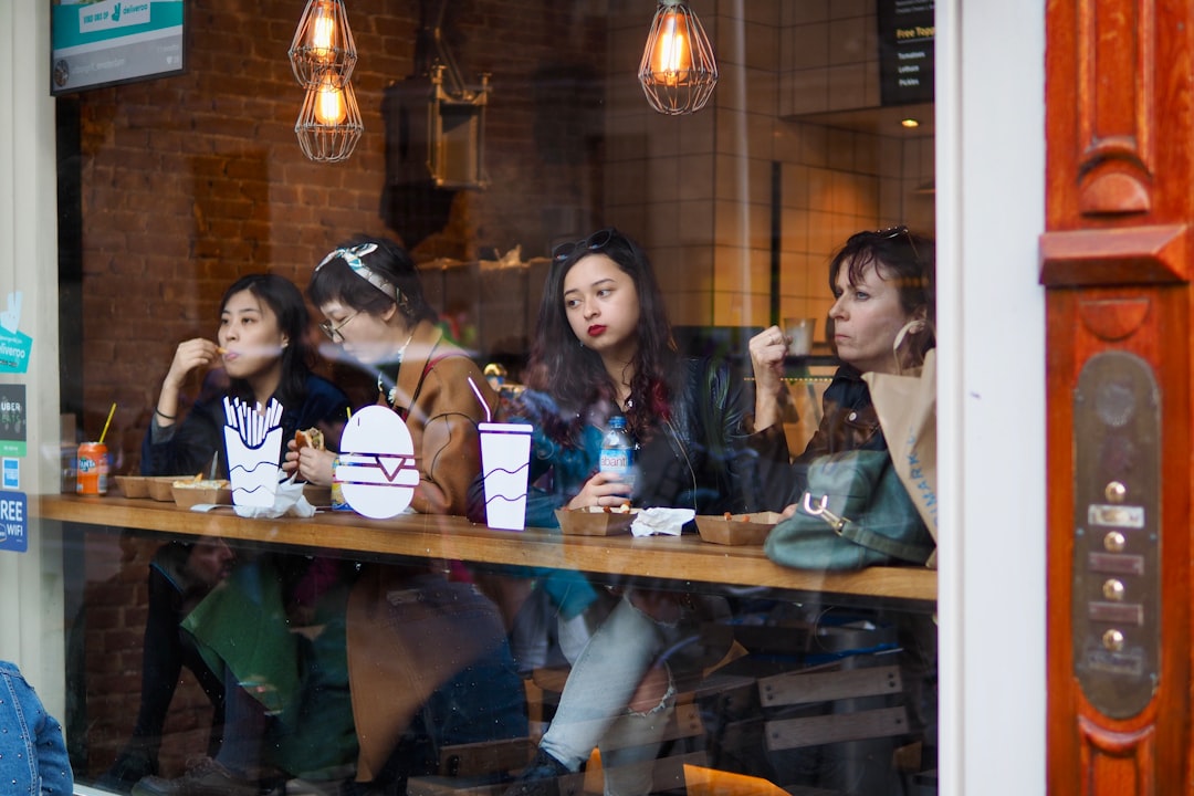 3 women sitting by the table